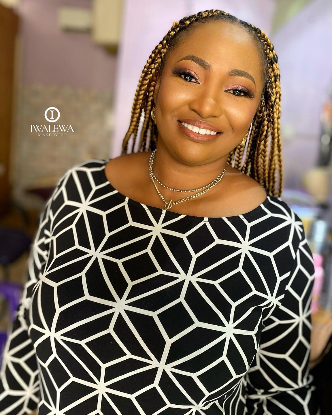 Smiling client with blonde braids and a polished beauty finish