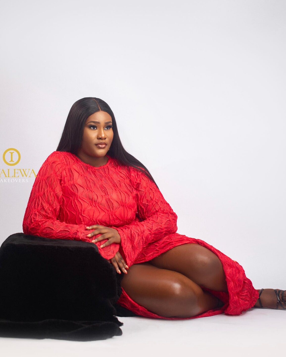 Studio portrait of a client in a red dress with polished makeup