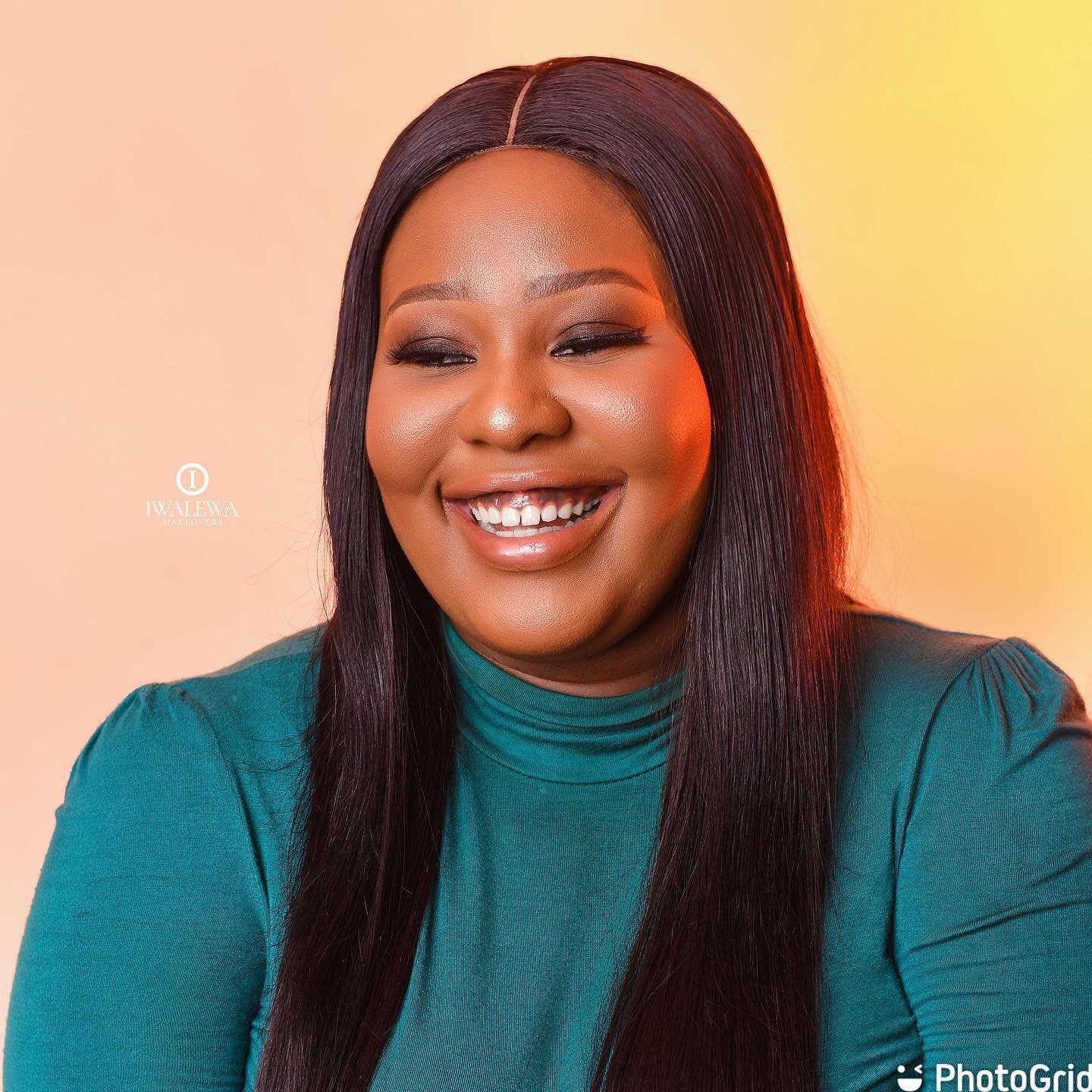 Smiling client in teal with glowing makeup and straight hair