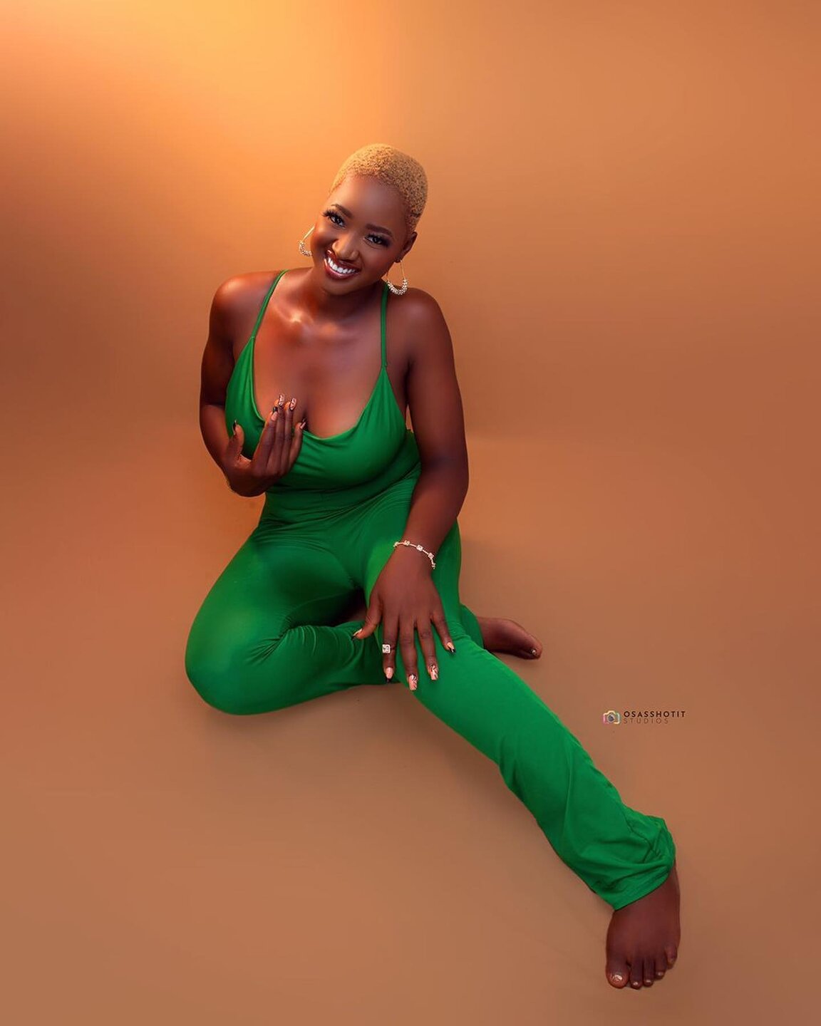 Full-length studio portrait of a client in a green jumpsuit